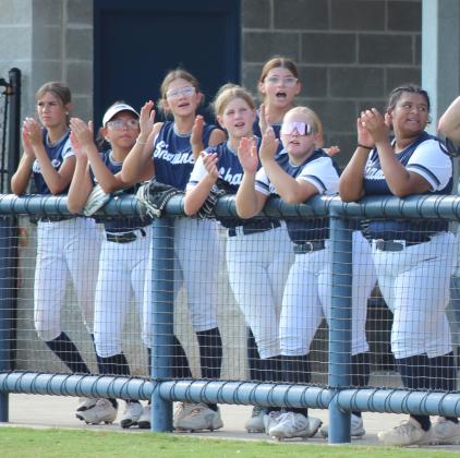 Shawnee High School Fast Pitch players cheers for their team at the home game on Aug. 22.