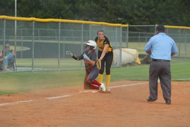 After catching the ball as a Prague runner dove into third base, Tecumseh junior Madison Gray makes the tag and looks to the referee for confirmation in the season-opening game on Aug. 12. The Lady Savages won, 10-7.