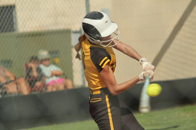 Tecumseh junior Haley Mansell makes contact at bat in the season-opening game against Prague on Aug. 12. The Lady Savages won, 10-7.