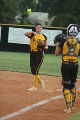 Tecumseh junior Jacee Townsend throws back to fellow junior Jalie Anderson after tagging a runner at first in the season-opening game against Prague on Aug. 12. The Lady Savages won, 10-7.