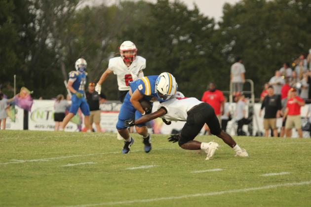 Bethel senior Leighton Swegheimer tries to guard the ball as McLoud freshman Anthony Gilliam takes out his legs during Bethel's first home game on Sept. 12. The Wildcats won, 58-32. Natasha Dunagan, Countywide &amp; Sun