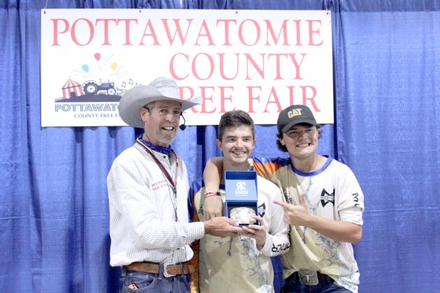 Amadeus Sandifer of Macomb took first place in the Big Bass Contest with a fish weighing 4 pounds, 2 ounces. He received a belt buckle at the Pottawatomie County Free Fair Awards on Sept. 6. Also shown are Jason Reynolds of the Fetch N' Fish Dog Show and Joel Vincent. Dace Dockrey placed second, and Shane Dockrey placed third.