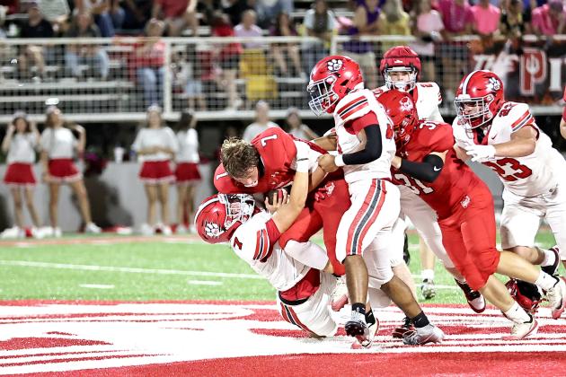 NRC's Cole Cossey puts a hard hit on the Prague player, who loses his helmet, in the Sept. 12 game. NRC won 45-0.