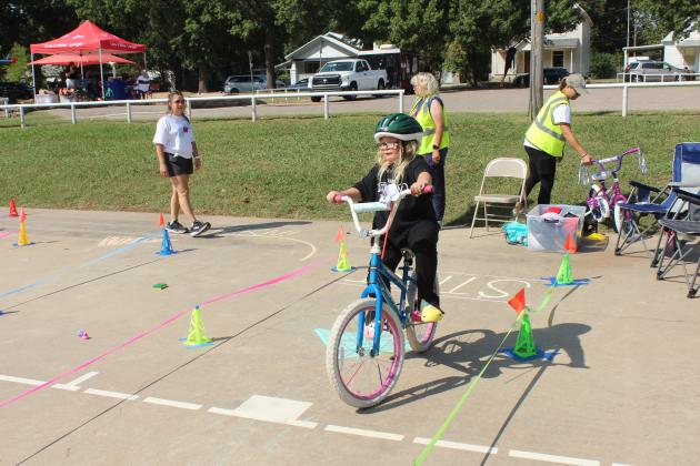 Zoe Miller, 8, of Shawnee, starts on the bicycle rodeo course, presented by Pottawatomie Go during Pedalpalooza, which was held at Rotary Briscoe Boy Scout Park on Sept. 20.