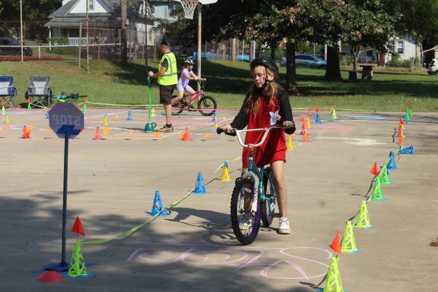 Lily Wright, 11, of Shawnee, sits at a stop sign in the bicycle rodeo, presented by Pottawatomie Go, during Pedalpalooza, which was held at Rotary Briscoe Boy Scout Park on Sept. 20. In addition to the bike rodeo, there were several booths, including Epic Snocones, First United Bank, VIPS, Kids Action, Pioneer Library Systems - Shawnee Library, OBU, Willier USA, Salty Dogs Cycling, Mabee-Gerrer Museum of Art, and LOL Cartoons Party Entertainment.