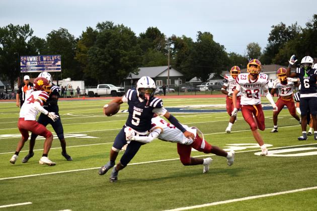 SHS's QB, Braylon Lassiter breaks a tackle to pick up a few yards.  The Shawnee Wolves won their season opener at home against PC North on Sept. 5 32-19 (last year PC North beat SHS 35-3 last season). Julie Talton, Countywide &amp; Sun