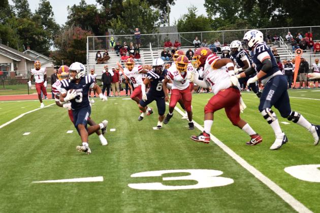 SHS's offensive line creates a hole for RB Dayton McClendon to score the first touchdown from a hand-off at the 34 yard line. The Shawnee Wolves won their season opener at home against PC North on Sept. 5 32-19 (last year PC North beat SHS 35-3 last season). Julie Talton, Countywide &amp; Sun