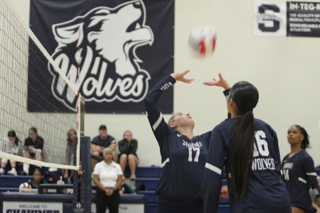 Shawnee sophomore Molly Megehee sets the ball during the Shawnee Volleyball Invitational Silver Bracket game, held at Shawnee Middle School on Sept. 20. The Gold Bracket games were played at Shawnee High School. The Lady Wolves won two games and lost three during the two-day tournament. Eight teams, including Tecumseh, participated.