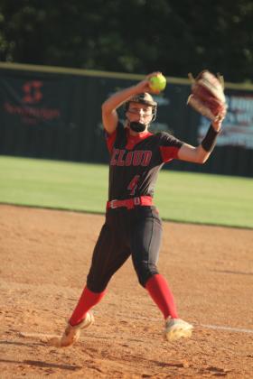 McLoud junior Ella Smith balances on one toe while winding up her pitch during the game at Tecumseh on Sept. 18. The Lady Redskins won, 3-7.