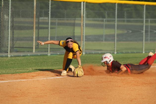 Tecumseh junior Madison Gray grabs the ball as McLoud sophomore Kayse Higdon dives into third base during the home game on Sept. 18. The Lady Redskins won, 3-7.