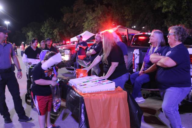 In addition to candy, members of the Tribbey Fire Department, including Randy Spring, Stacy Spring, Laurie Spring and Mindy Rodman, gave away scented markers, Play Doh, chalk and hats during the Second Annual First Responders Trunk or Treat, held in the FireLake Arena parking lot on the evening of Oct. 25.