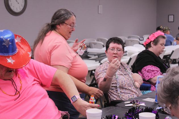 Shawnee American Legion Auxiliary Vice President Jamie McCraw waits as Kim Ellis picks out a bracelet after getting a bingo on Oct. 15. This was the third time for American Legion Gill-Mattox Post 16 offered a special time - on the third Wednesday of each month - for nursing home residents to play bingo.