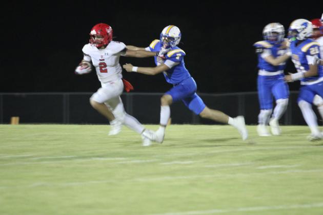 Bethel freshman Ridge Cator runs after the Prague ball carrier during the first quarter of the home game on Sept. 26. The Wildcats won, 58-6.