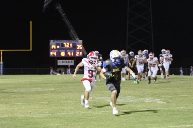 Bethel senior Zack Jennings makes the carry with the Kingston defense on his heels during the second quarter of the Military Night home game on Oct. 10. The Wildcats lost, 44-73, giving them a record of 5-1.
