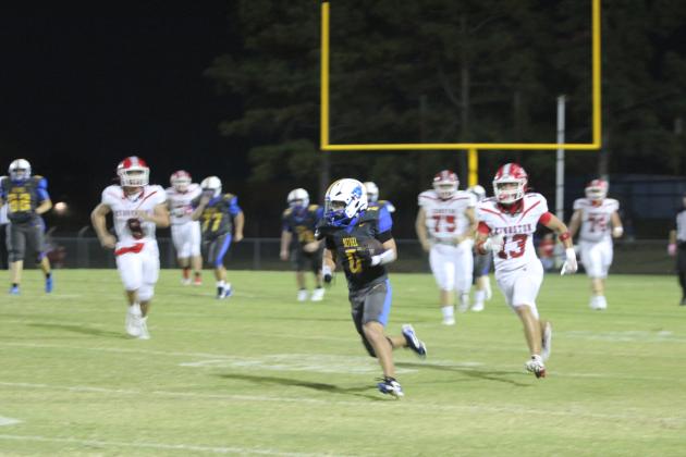 Bethel senior Leighton Swegheimer carries the ball for a first down and 10 during the Military Night home game against Kingston on Oct. 10. The Wildcats lost, 44-73, giving them a record of 5-1.