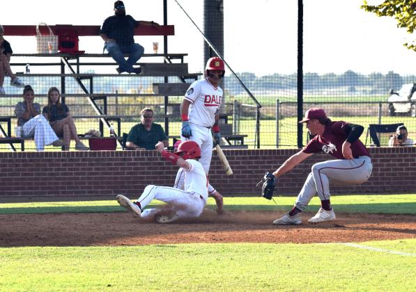 Dale's batter Andrew Collins steps aside so Chase Harris can slide into home during the game against Byng on Sept. 25. Dale won 11-3. Julie Talton, Countywide &amp; Sun