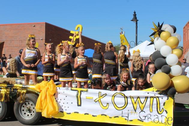 Tecumseh fourth-grade cheerleaders give the "SAVAGES" cheer as they ride in the Frontier Days Parade on Sept. 27.