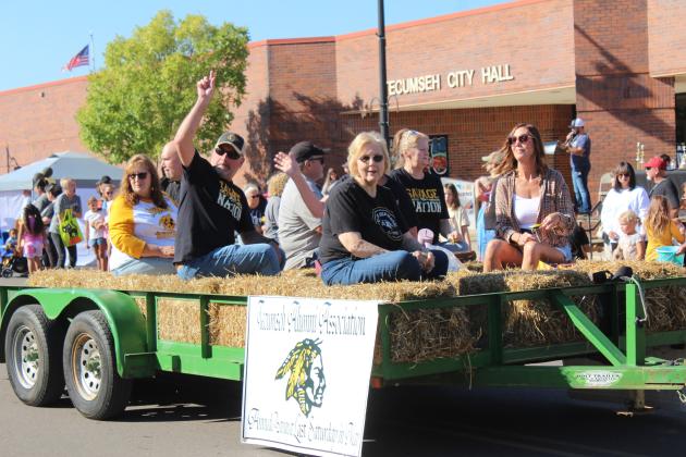 Members of the Tecumseh Alumni Association ride on their float in the Frontier Days Parade, Sept. 27.