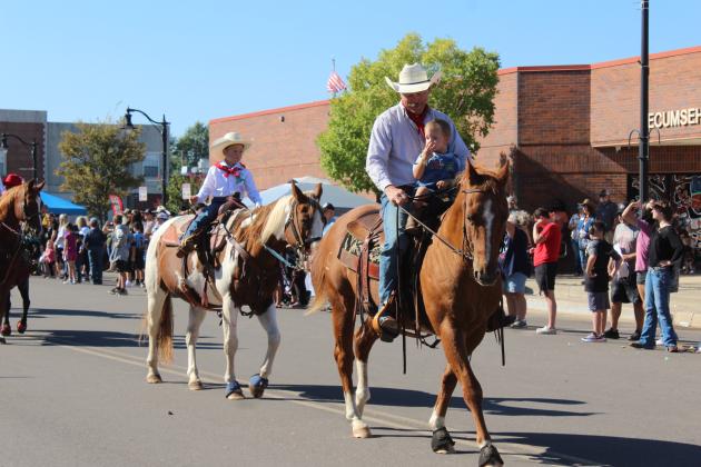 Members of the Tecumseh Roundup Club ride their horses in the Frontier Days Parade on Sept. 27.