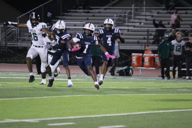 Shawnee sophomore Garret McCurdy runs the ball after making an interception for a first down in the first quarter of the Oct. 23 homecoming game.