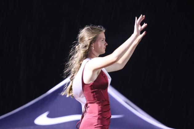 Shawnee Drum Major and Homecoming Queen Kiley Sartin leads the SHS Pride of the Pack Marching Band during halftime of the Oct. 23 homecoming game. At the end of their performance, the game was called due to lightning in the area.