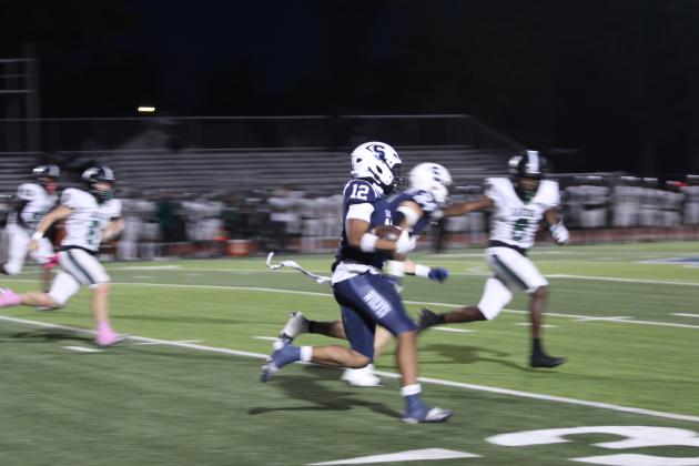 To open their homecoming game on Oct. 23, Shawnee senior Dillion Simmons caught the kickoff return and made a 95-yard touchdown run in 10.2 seconds. Photos by Natasha Dunagan, Countywide &amp; Sun