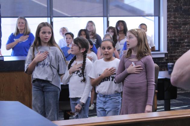 Four members of the Sequoyah Leadership Team - Ivy Budka, Rylee Haywood, Aixia Gonzales, Cecelia Geiger - lead the Pledge of Allegiance at the Oct. 6 Shawnee School Board meeting.