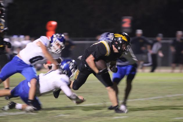 Tecumseh sophomore Jackson Douglas barrels through the Harrah defense to make a touch down during the second quarter of the Homecoming game on Oct. 3. The Savages lost, 23-49. Natasha Dunagan, Countywide &amp; Sun