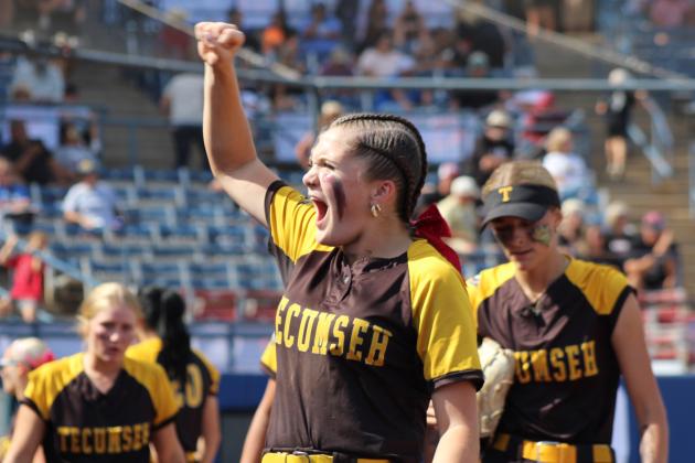 Tecumseh junior Josie Walker rallies the fans, before descending into the dugout and going to bat, in the seventh inning of the Class 4A Fast Pitch State Quarterfinal game against Tuttle on Oct. 16.