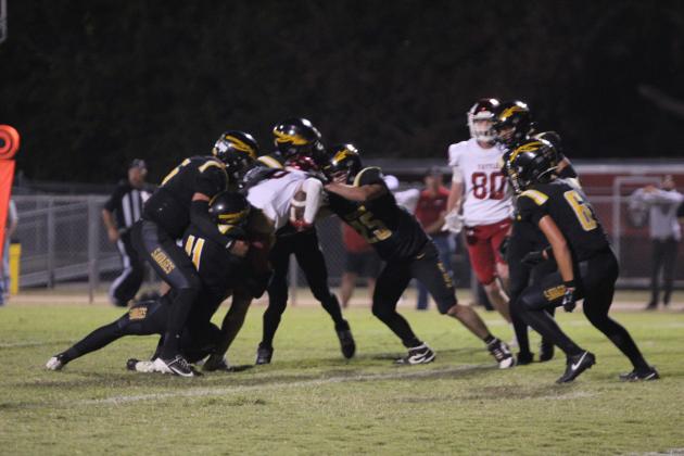 The Tecumseh Savage defense works to bring down the Tuttle ball carrier in the second quarter of the Oct. 16 home game against Tuttle. The Savages lost 6-70.
