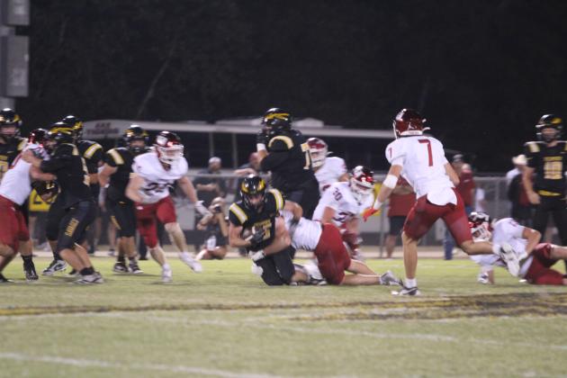Tecumseh senior Wyatt McElfresh gains two yards for a third down in the second quarter of the Oct. 16 home game against Tuttle. The Savages lost 6-70.