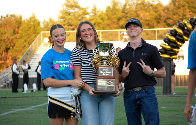 Seniors Addison Taron, Kalyn Bartmess and Blake Wright, accept the Gold Crush Award at the Homecoming festivities for having the most spirit at the high school. Savannah Talton, Countywide &amp; Sun