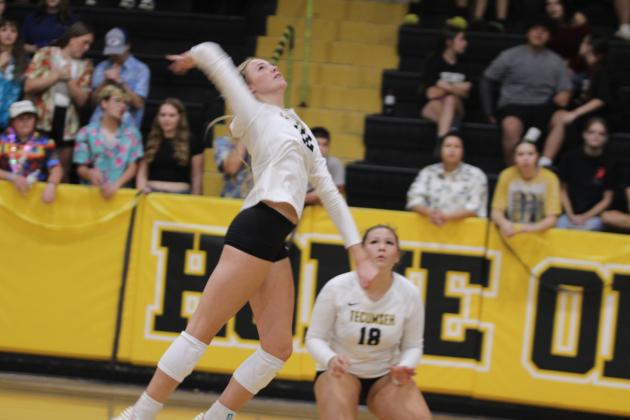 Tecumseh senior Kennadee Mason jumps to attack the ball during the Senior Night home match with Cache on Oct. 2. Mason recently reached 1,000 volleyball kills, the first in Tecumseh High School history to do so. Also shown is sophomore Aivah Dodgion. Natasha Dunagan, Countywide &amp; Sun