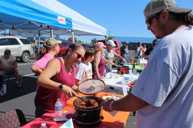 Ronnelle Baker serves up "The House Divided" chili for Kerry Nanaeto, of Shawnee, during the Second Annual Worrell's Haven Chili Cook Off, held in the Shawnee High School parking lot on Oct. 4. The event had an "OU versus OSU" tailgating theme, and attendees could vote on 18 types of chili. This is one of two annual fundraisers for the women's recovery house. Next, they will have Glow-in-the-Dark Bingo in April.