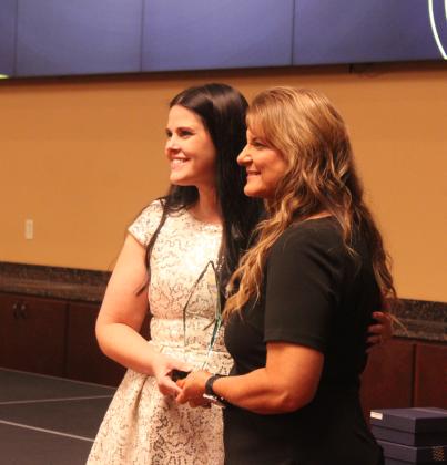 Last year's winner, Katie McMahan, presents the Businessperson of the Year Award to Kendra Sullivan, owner of The Farmer's Daughter Market, during the Tecumseh Chamber of Commerce Annual Meeting and Awards Banquet, held at the Grand Casino Hotel and Resort on Nov. 20. Natasha Dunagan, Countywide &amp; Sun