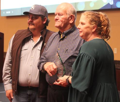 Kacy Kinsey, right, last year's winner representing AECO Sales &amp; Services, presents the Legacy Award to Jim Allman, center, and Bill Coker with 4-Way Automatic Transmissions. Natasha Dunagan, Countywide &amp; Sun