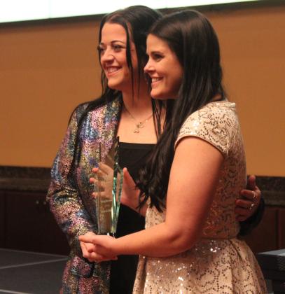 Katie McMahan, right, last year's winner, passes on the Rising Star Award to Annie Jo Gilbert during the Tecumseh Chamber of Commerce Annual Meeting and Awards Banquet, held at the Grand Casino Hotel and Resort on Nov. 20. Gilbert also accepted the Citizen of the Year Award on behalf of her mother, Suzanne Gilbert, who was unable to attend. Natasha Dunagan, Countywide &amp; Sun