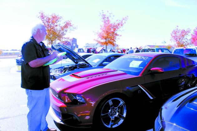 Rick Stiles looks over a 2014 Mustang Roush in his rounds as a judge.