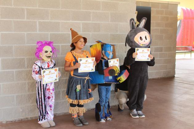 Riley Little, Alexia Nsabimana, Ezra Hilton and Azden Budka were the winners of the Shawnee Fall Festival Costume Contest in the 8-13-year age range on Nov. 1 at Woodland Veterans Park.