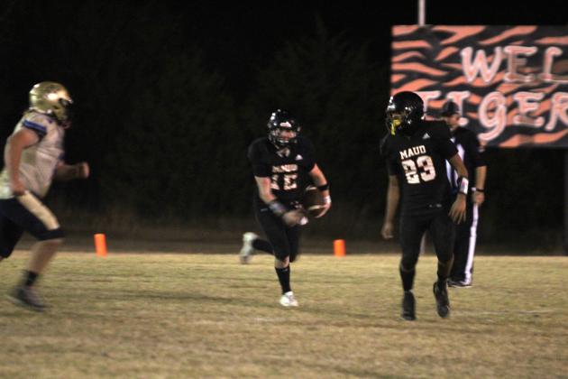 Maud's Colt Bassett gains yardage in the fourth quarter of the Class C First Round Football Playoffs home game against Bluejacket on Nov. 14. The Tigers won 46-28 and will now play in the quarterfinals at Timberlake on Nov. 21 at 7 pm, according to www.ossaarankings.com.