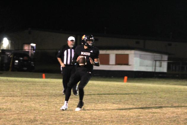 Maud sophomore Trenton Marshall looks to pass before running a quarterback keeper.
