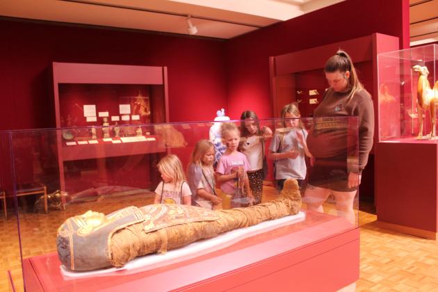 Five girls and a woman admire the Egyptian mummy known as Tutu, formerly Princess Menne, during the Fifth Annual Mummy Day at the Mabee-Gerrer Museum of Art in Shawnee, Nov. 8. There were about 917 visitors to the museum that day, according to Director of Development Sylwia Partyka. For more information on the Egyptian collection, visit https://www.mgmoa-gallery.com/ .