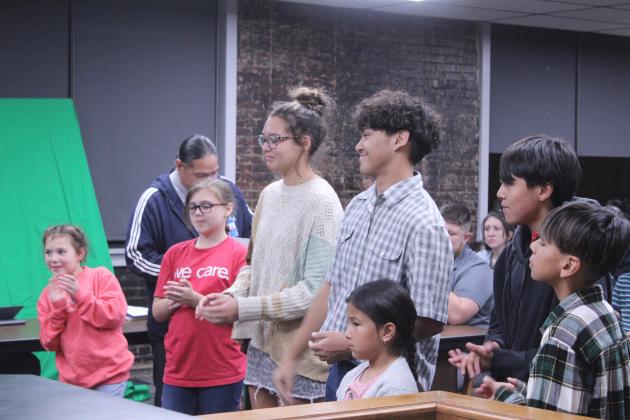 Seven of the 13 Jim Thorpe Art Contest winners from all grade levels were recognized during the Nov. 3 Shawnee Board of Education meeting and introduced by Indian Education Director Graham Primeaux.  They are, from left, Amara-Nichelle Johnson, Aurora Cullum, December Nanaeto, Kaden Johnson, Malachi Pocowatchit, Gabriel Moreno, and, in front, Amari Gibson.