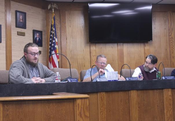 Shawnee Board of Education member Turner Bass asks questions about the incident which led to Cyndi Berger's removal from school premises before voting no on the superintendent's recommendation during a Special Session on Nov. 20. Also shown are Russ Oliver and Board President Clif Harden. Natasha Dunagan, Countywide &amp; Sun