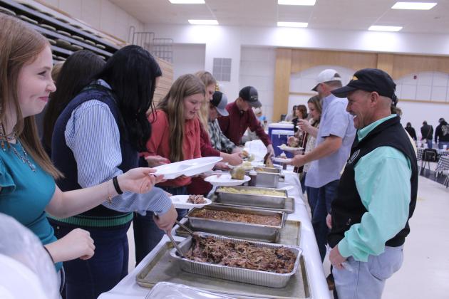 Oklahoma State Representative Danny Sterling, a former Tecumseh Ag Teacher, goes through the Tecumseh FFA Pig Roast line at the THS Alumni Center on Nov. 21. Tecumseh FFA students serving, from left, are Lexus Wood, Maci Peacock, Hailee Townsend, Addison Arnold, Caden Love and Lyric Morrison. Natasha Dunagan, Countywide &amp; Sun