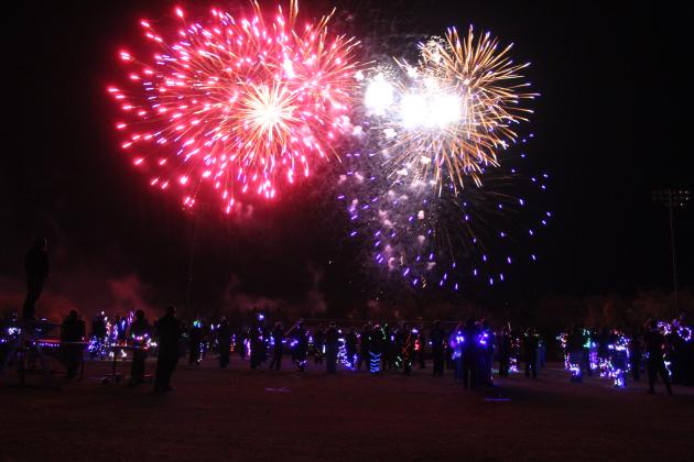 The Tecumseh, Meeker and North Rock Creek High School bands share the THS football field to play 'The Stars and Stripes Forever' by John Phillip Sousa, with a background of fireworks.