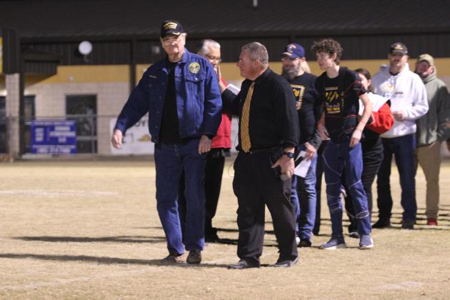 Tecumseh Band Director John Outon, right, encourages a Vietnam veteran during the Veteran's Parade of the Veteran's Day Light Show, held at the THS football field on Nov. 11.