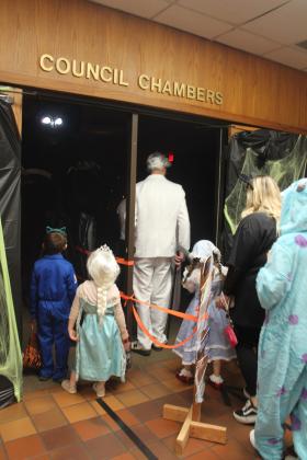 A couple of children hesitate to enter the haunted house set up in the Tecumseh City Council Chambers during the Tecumseh Business Treat 'r Treat on Oct. 31. The glowing eyes were from a tall animatronic witch at the entrance.