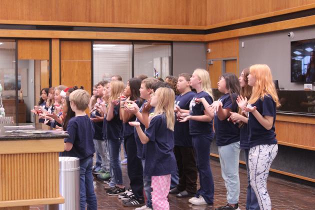 Will Rogers Elementary Choir members sing "Holly Jolly Christmas" during the Salvation Army Angel Tree Kickoff event at Sovereign Bank in Shawnee on Nov. 20. Co-Captains Leanna and Thomas Marion, and Women's Auxiliary Angel Tree Coordinator Robbie Foxx spoke during the event.