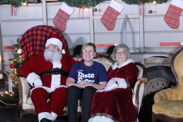 ONE Church Youth Pastor Summer Cash sits with Santa and Mrs. Claus at the Cocoa Corner event on Dec. 11. With help from the youth, Cash operates the nonprofit "Come Taste and See" food truck and catering, with all proceeds going toward the church's missions and community projects. ONE, formerly Tecumseh Pentecostal Church of God, also offered kiddie train rides, a snow globe bounce house, cookie decorating and an ornament craft, in conjunction with the Tecumseh Chamber of Commerce Grinchmas Parade.